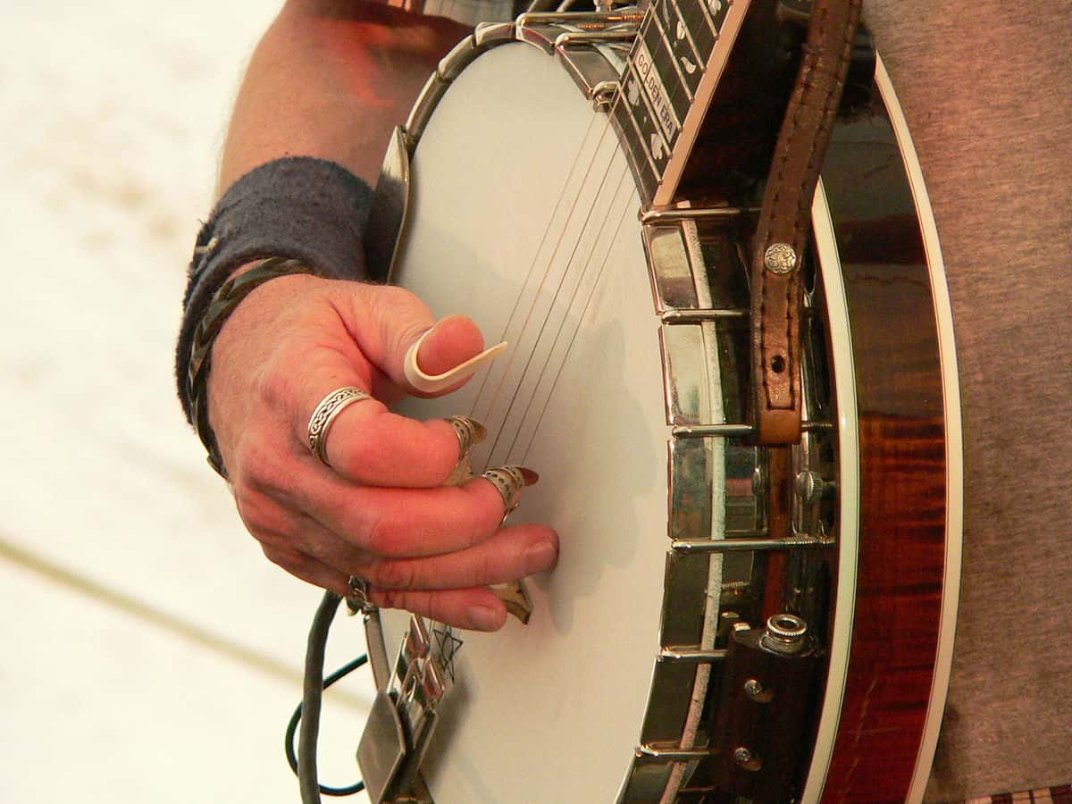 Man Playing Banjo with Finger Picks
