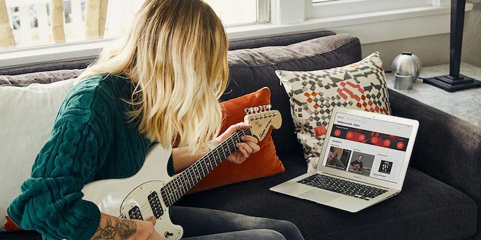 Girl Learning Electric Guitar Online