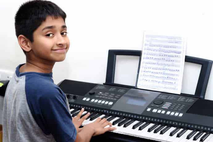 Beginner Student Learning Piano on Keyboard