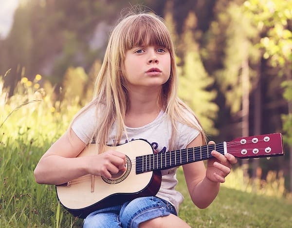 Girl Playing a Small Acoustic Guitar