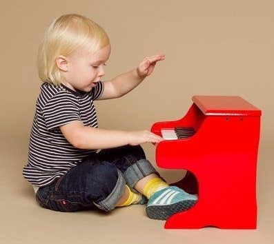 Toddler Playing Red Piano