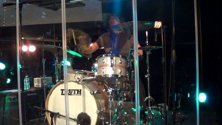 Drummer Playing inside a Drum Shield