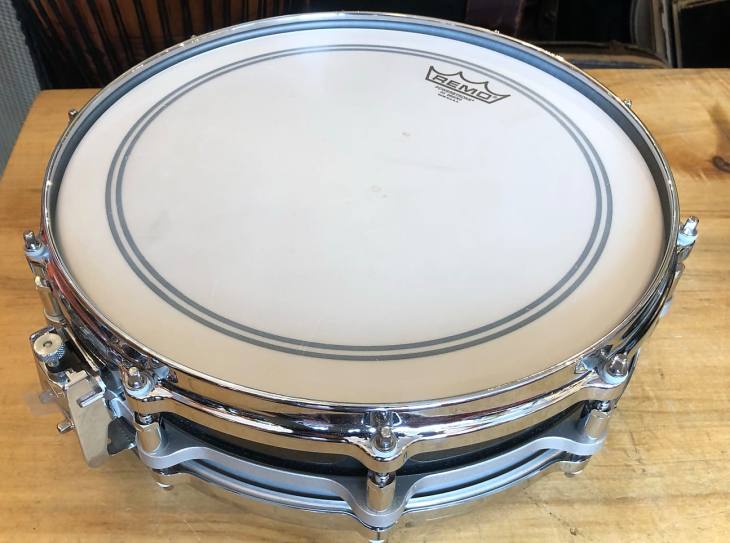 Pearl Piccolo Snare on a Wooden Table
