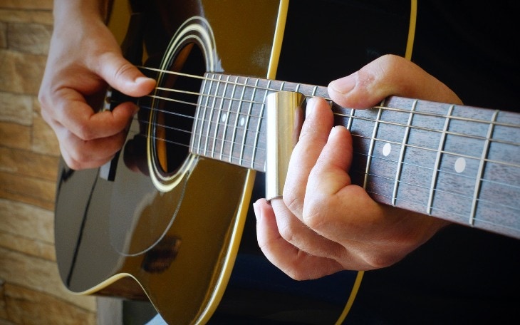 Man Playing Blues on a Black Acoustic Guitar